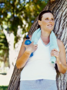mid adult woman with a towel on her shoulders in a park